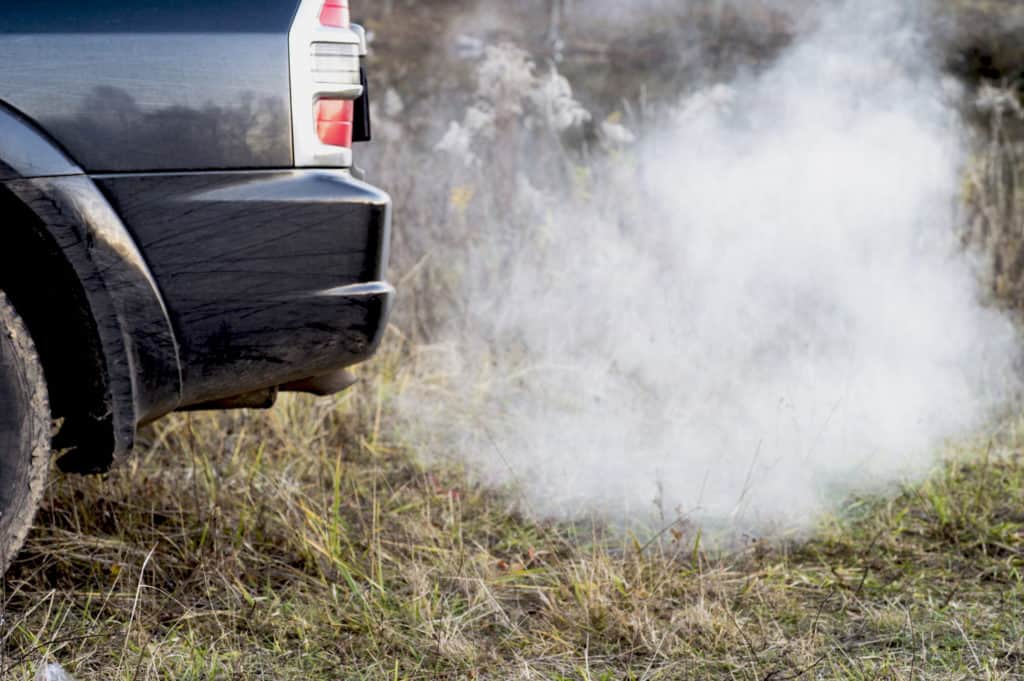 Continuous white smoke when driving is a sign of a coolant leak
